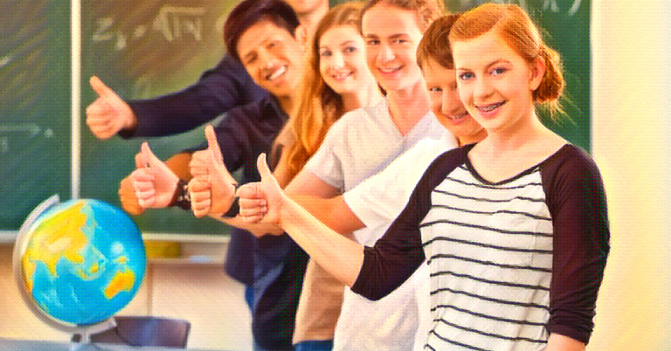 A group of middle school students in a classroom give a thumbs up for this day's lesson plans