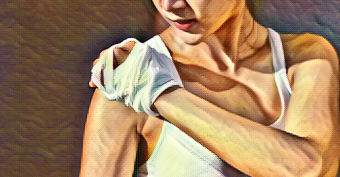 a woman with a bandaged hand holds her shoulder as if it hurts