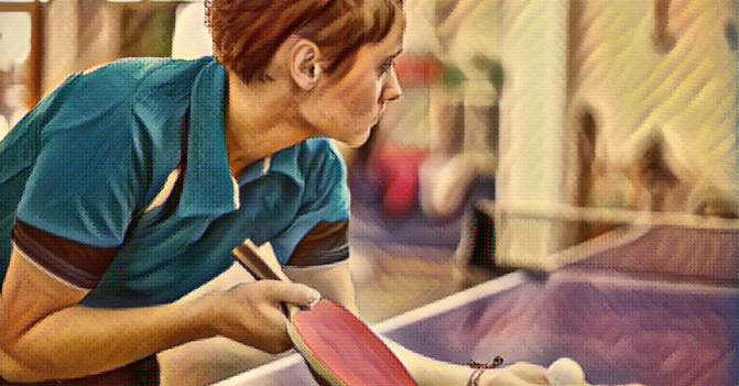 girl with short hair and blue polo shirt prepares to serve in a ping pong game