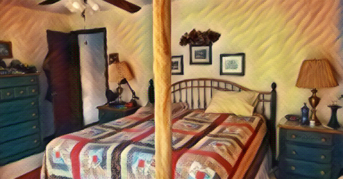 A traditional looking bedroom with a king-size bed, night stands, and dresser -- and a tall wooden pole fitting floor to ceiling