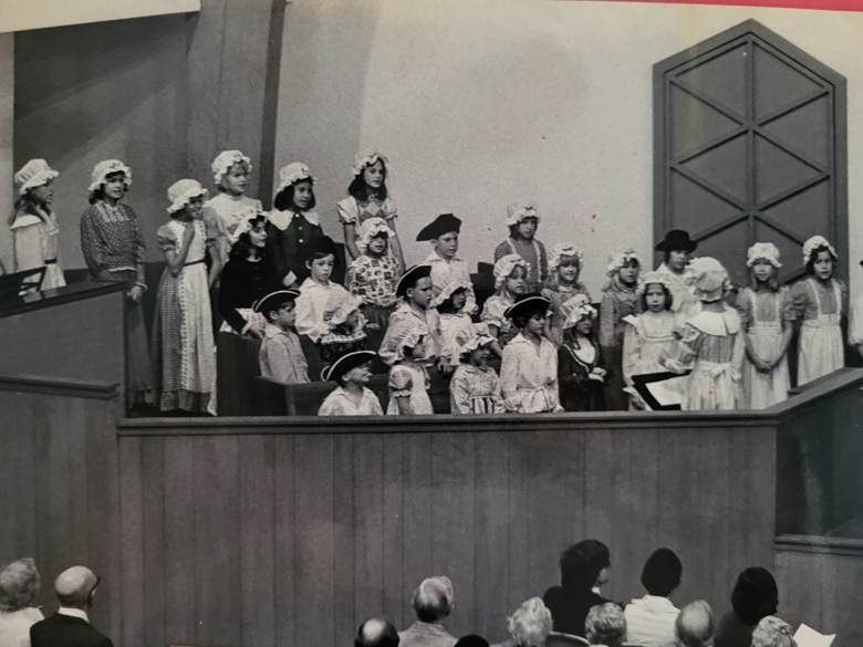 The photo shows a children's church choir, all the participants dressed in colonial attire in honor of the United States' bicentennial in 1976.